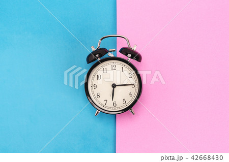 Vintage alarm clock on pink and blue background 42668430
