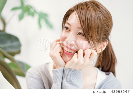 頬杖をついて甘えた目線で相手を見つめる女性 42668547