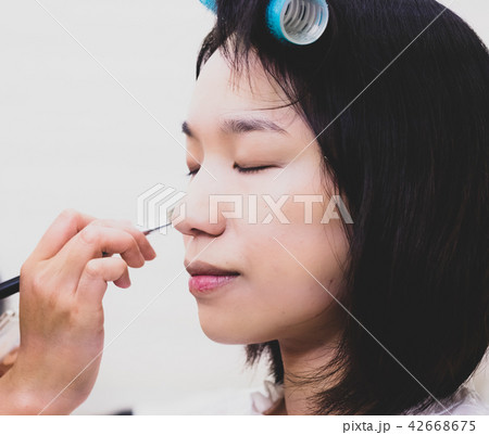 Young woman with makeup cosmetics 42668675