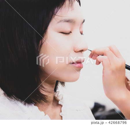 Young woman with makeup cosmetics Young woman with makeup cosmetics 42668796