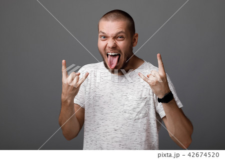 young man showing rock gesture young man showing rock gesture 42674520