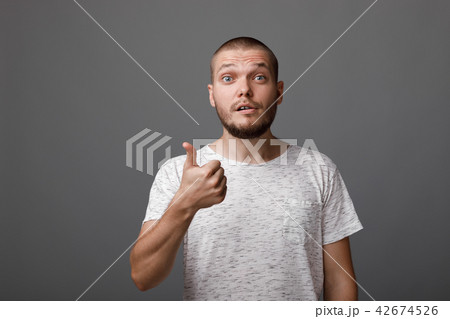 young man showing a thumbs up gesture young man showing a thumbs up gesture 42674526