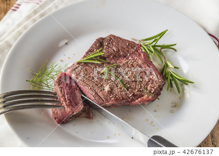 Cuting of delicious beefsteak with pepper Cuting of delicious beefsteak with pepper 42676137