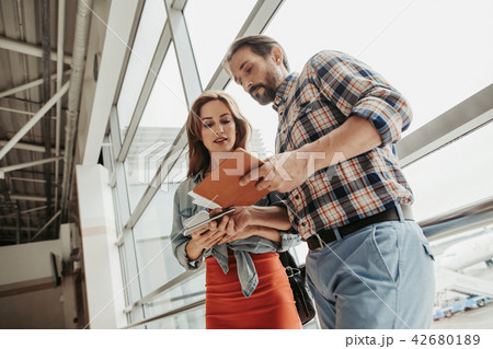 Focused male and lady watching at phone 42680189