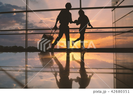 Cheerful girl holding glad male arm 42680351