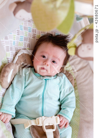 Newborn baby boy sitting in his swing Newborn baby boy sitting in his swing 42680671