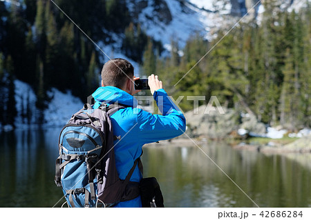 Backpacker taking photo with smartphone 42686284