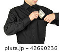 Businessman putting money in shirts' pocket 42690236