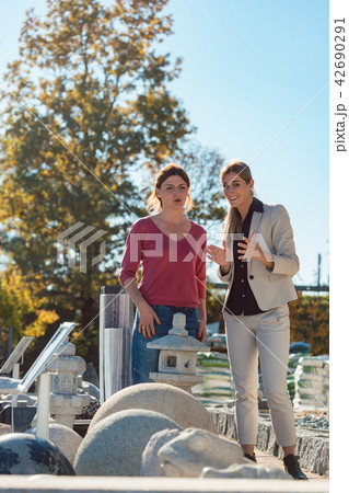 Two women in store selling nature stone Two women in store selling nature stone 42690291