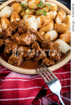 Beef stew with potatoes dumplings. 42693616
