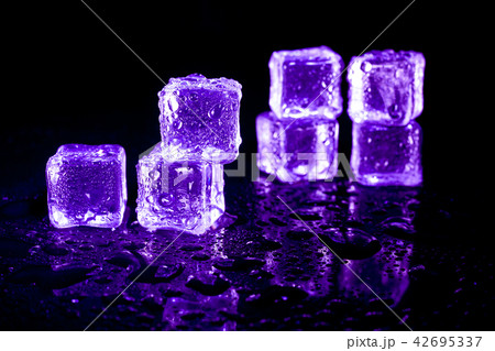 Purple ice cubes reflection on black background. 42695337