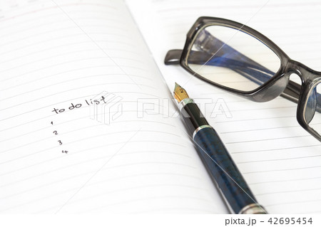 writing to do list on notebook page with pen 42695454