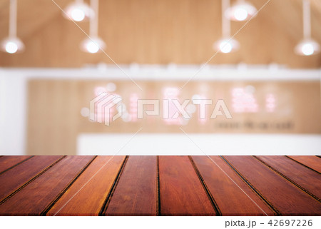 Empty wooden table and blurred background of abstract in front o 42697226