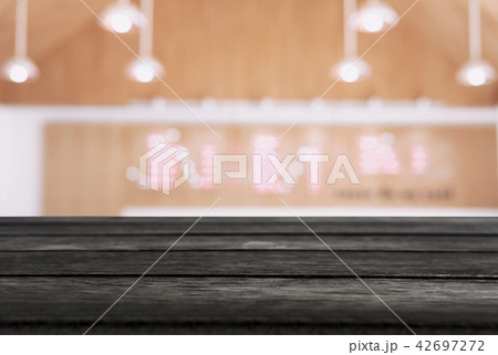Empty wooden table and blurred background of abstract in front o Empty wooden table and blurred background of abstract in front o 42697272