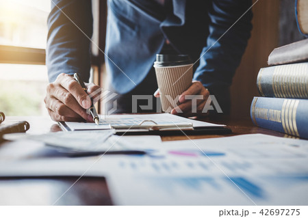 Businessman pointing at graph and chart to analysis use for plan Businessman pointing at graph and chart to analysis use for plan 42697275