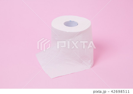 The roll of white toilet tissue paper on pink back 42698511