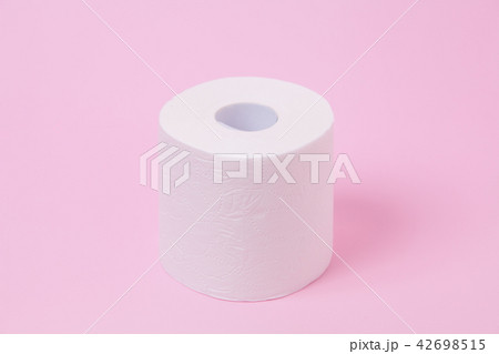 The roll of white toilet tissue paper on pink back The roll of white toilet tissue paper on pink back 42698515