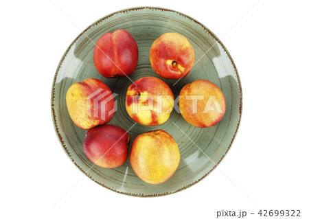 nectarine in a clay plate 42699322
