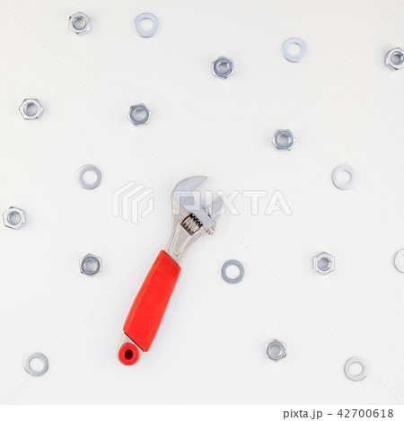 Flat lay of metal nuts and spanner Flat lay of metal nuts and spanner 42700618