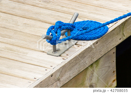 Yachting detail, blue rope and mooring bollard Yachting detail, blue rope and mooring bollard 42708035