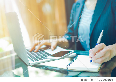 Businesswoman is taking notes on a pen. 42708904