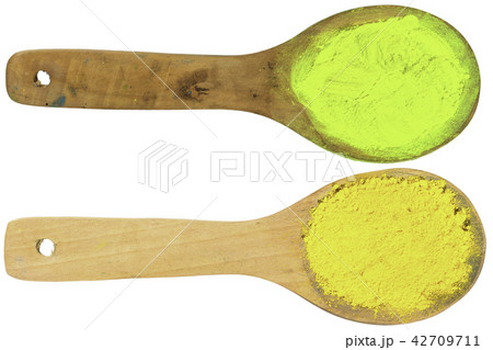 yellow powder on wooden spoons with clipping path 42709711
