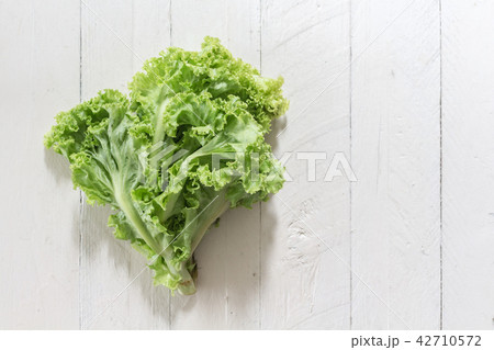 Lettuce leaves on wooden background 42710572