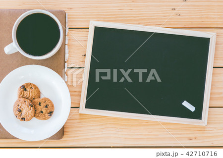 Blackboard and cup of coffee with cookies Blackboard and cup of coffee with cookies 42710716
