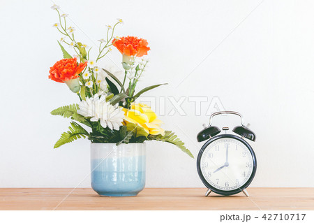 Still life with flowers on wooden table 42710717