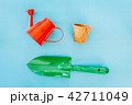 Watering can on blue background 42711049