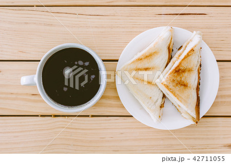Sandwich with coffee cup on wooden table 42711055