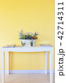 white basket on white table with yellow wall 42714311