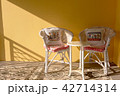 the empty chairs on yellow background with sunligh 42714314