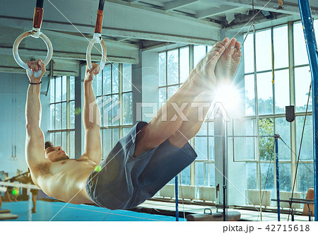 The sportsman during difficult exercise, sports gymnastics The sportsman during difficult exercise, sports gymnastics 42715618