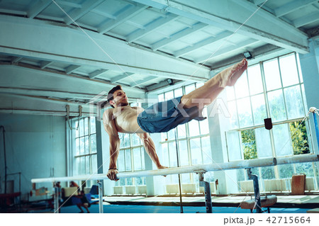 The sportsman during difficult exercise, sports gymnastics 42715664