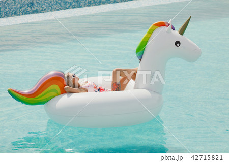 Enjoying suntan Woman in bikini in the swimming pool. Summer Vacation Enjoying suntan Woman in bikini in the swimming pool. Summer Vacation 42715821