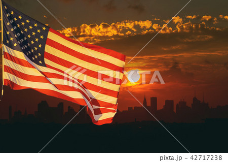 The American flag waving in View of Manhattan 42717238