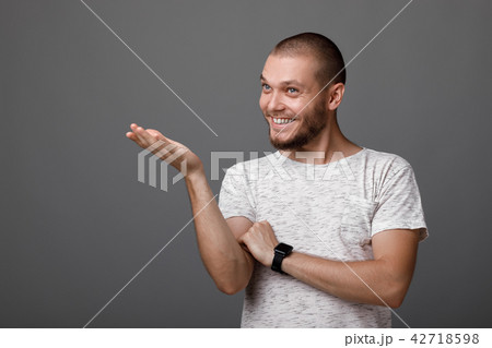 smiling man pointing copy space smiling man pointing copy space 42718598