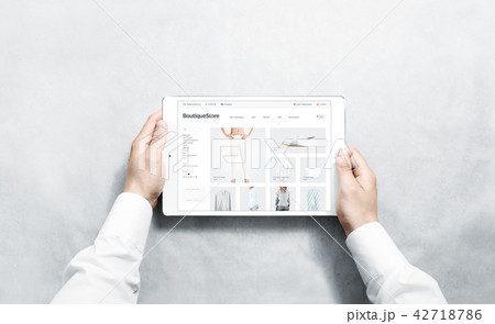 Hands holding tablet with fashion webstore mock up Hands holding tablet with fashion webstore mock up 42718786