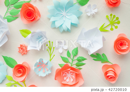 color paper flowers on the white stucco. color paper flowers on the white stucco. 42720010