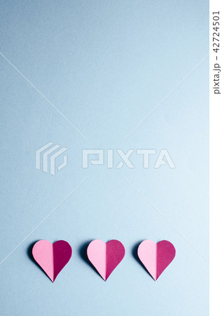 Paper hearts on blue background Paper hearts on blue background 42724501