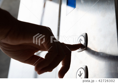 Close up waman hand press a up button of elevator 42726302