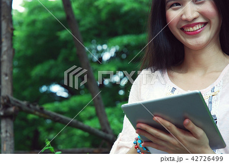 Beautiful girl happy playing tablet device working Beautiful girl happy playing tablet device working 42726499