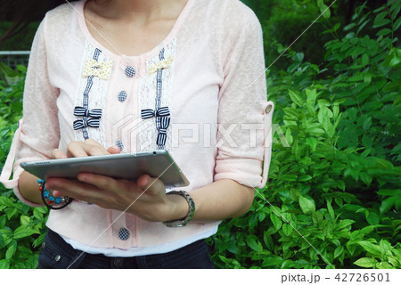 Beautiful girl happy playing tablet device working Beautiful girl happy playing tablet device working 42726501