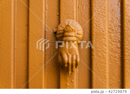 Door with brass knocker in the shape of a decor 42729879