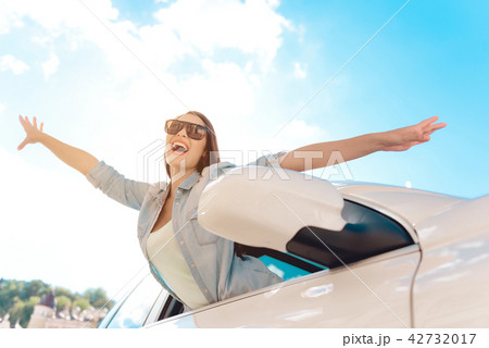 Cute Laughing Young Woman Hanging out from Car. Cute Laughing Young Woman Hanging out from Car. 42732017