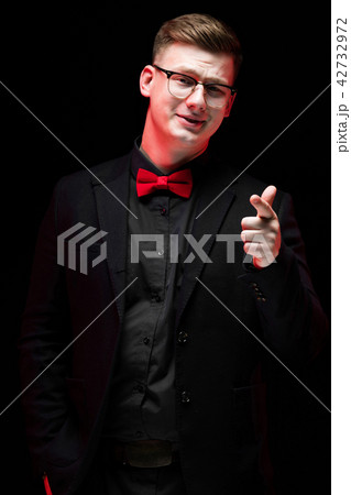 Portrait of confident handsome elegant responsible businessman pointing at camera on black 42732972