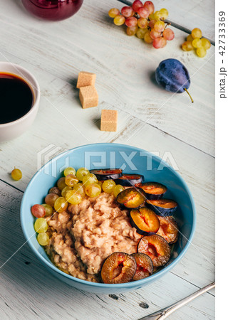 Porridge with fresh fruits and cup of coffee. Porridge with fresh fruits and cup of coffee. 42733369
