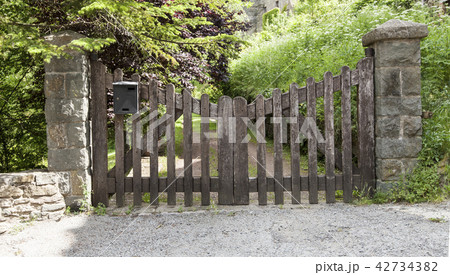 Wooden gate in a stone wall on a farm 42734382