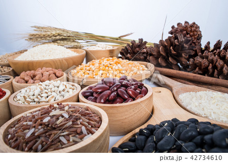 Cereal grains , seeds, beans on wooden background Cereal grains , seeds, beans on wooden background 42734610